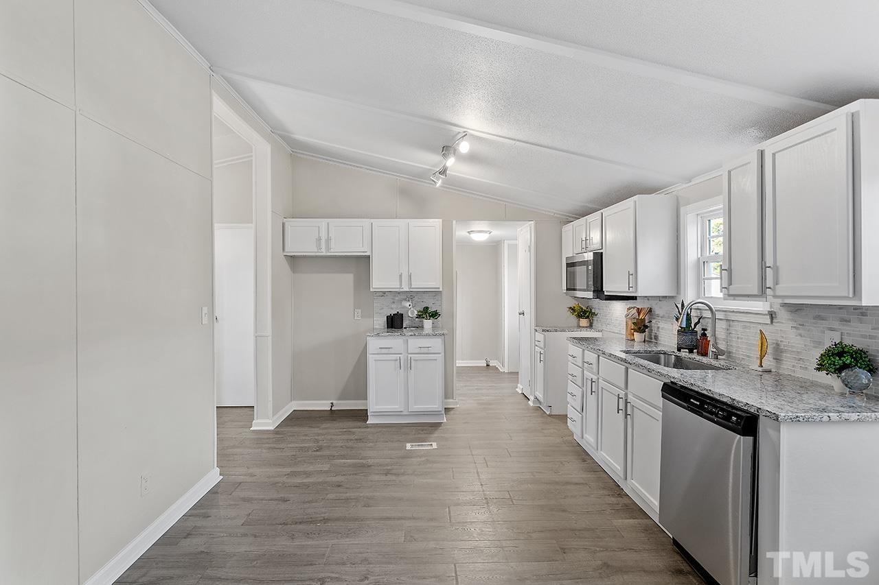 313 Smith Road Smithfield, NC 27577 - Photo 11 of 36 a kitchen with white cabinets and white appliances