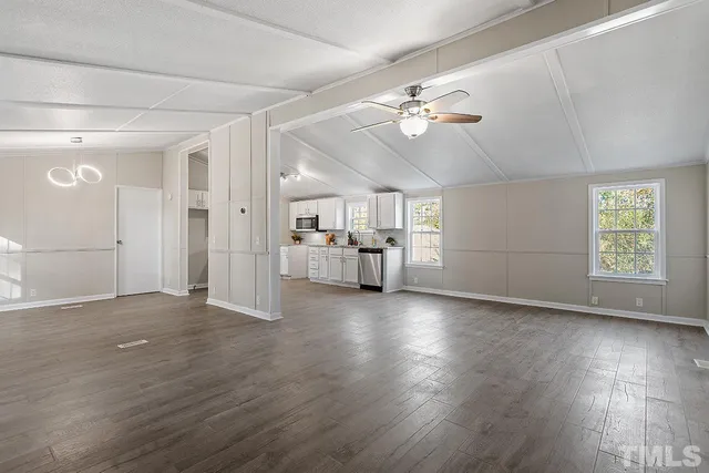 a view of a livingroom with hardwood floor and a ceiling fan
