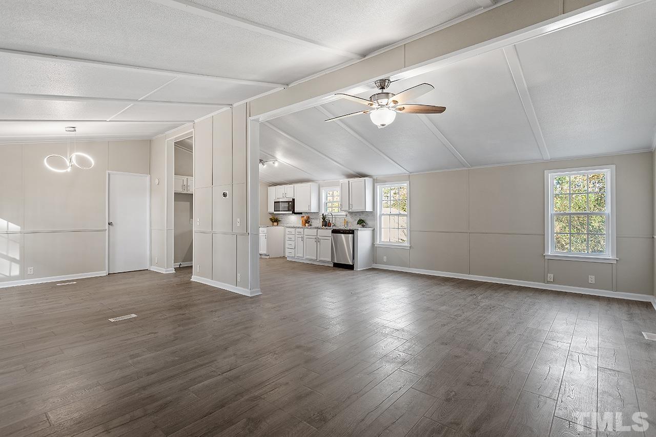 313 Smith Road Smithfield, NC 27577 - Photo 16 of 36 a view of a livingroom with hardwood floor and a ceiling fan