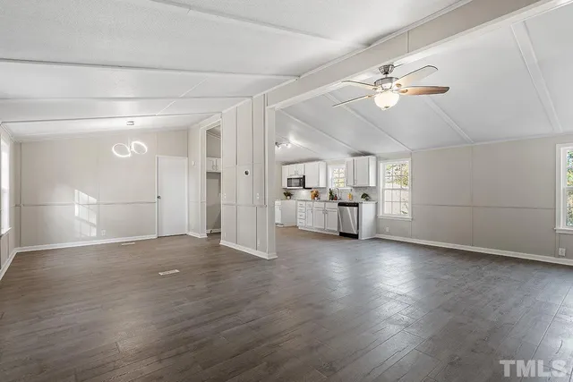 a view of a livingroom with furniture wooden floor and a chandelier