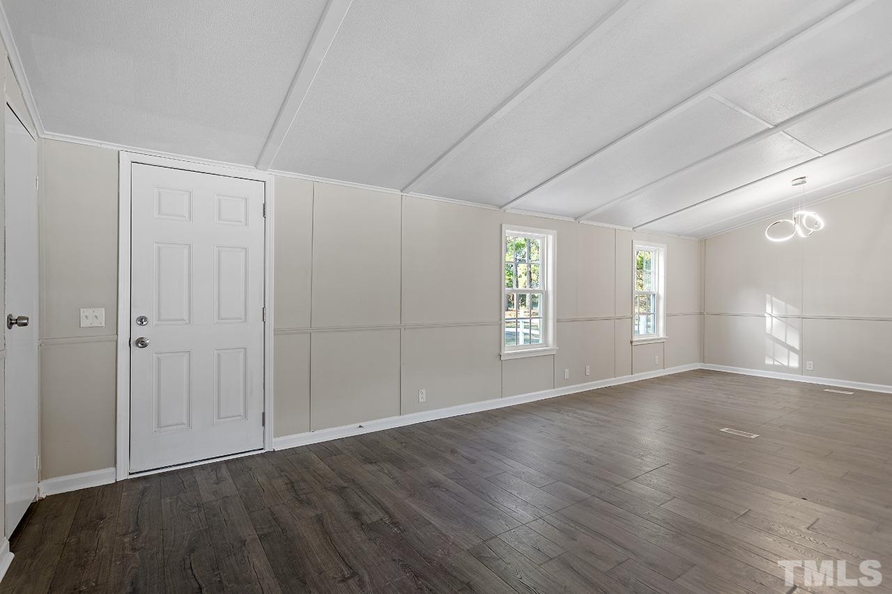 313 Smith Road Smithfield, NC 27577 - Photo 18 of 36 a view of an empty room with wooden floor and a window