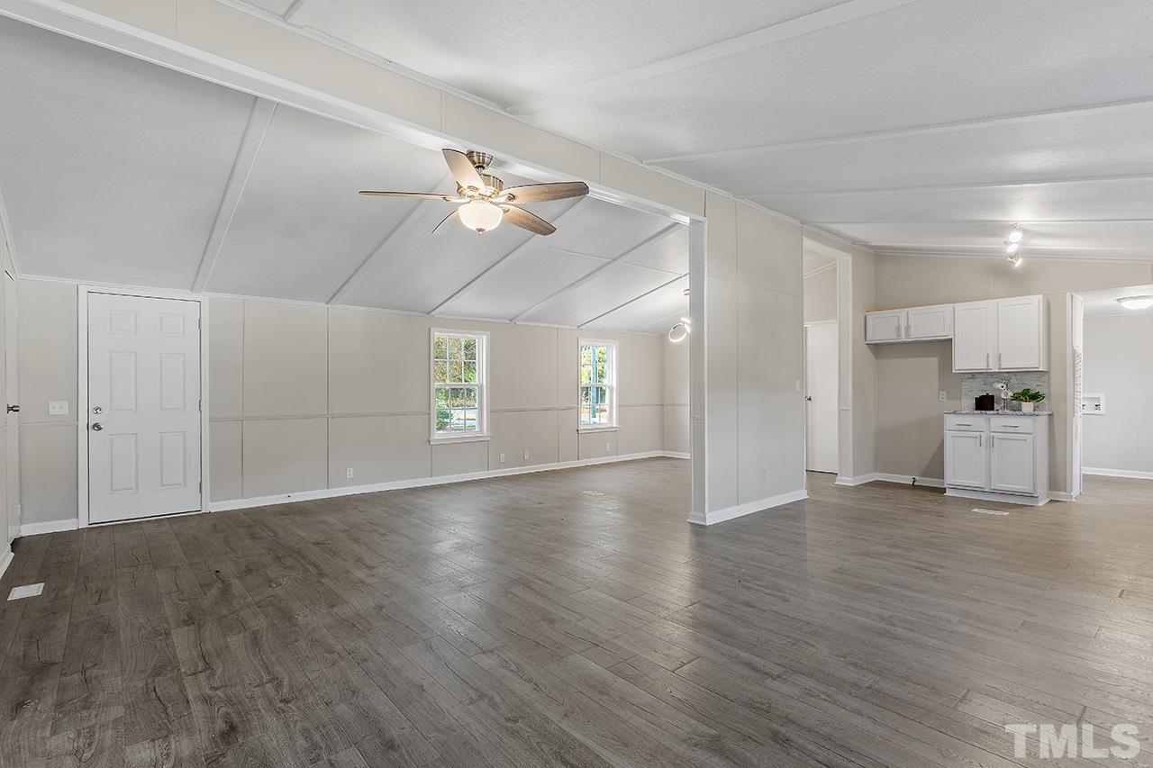 313 Smith Road Smithfield, NC 27577 - Photo 23 of 36 a view of empty room with wooden floor and ceiling fan