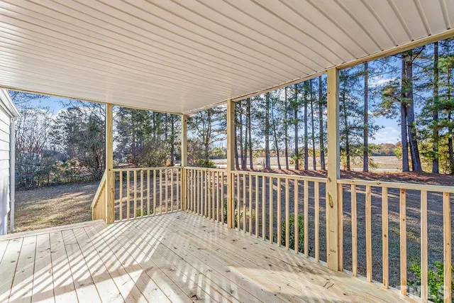 a view of balcony with wooden floor