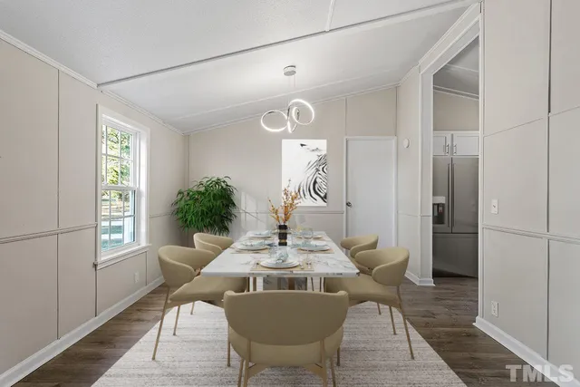 a view of a dining room with furniture and a window