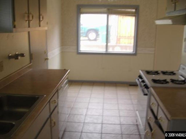 540 Wellington Way Reno, NV 89506 - Photo 3 of 8 a kitchen with a stove a sink and a refrigerator