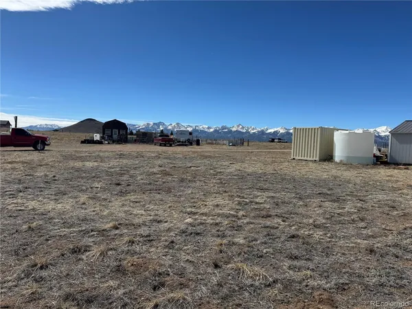 a view of a large mountain with sunset in the background