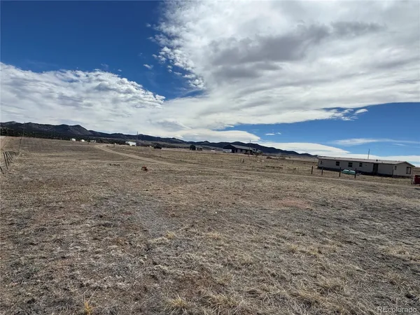 a view of a lake with houses in the back