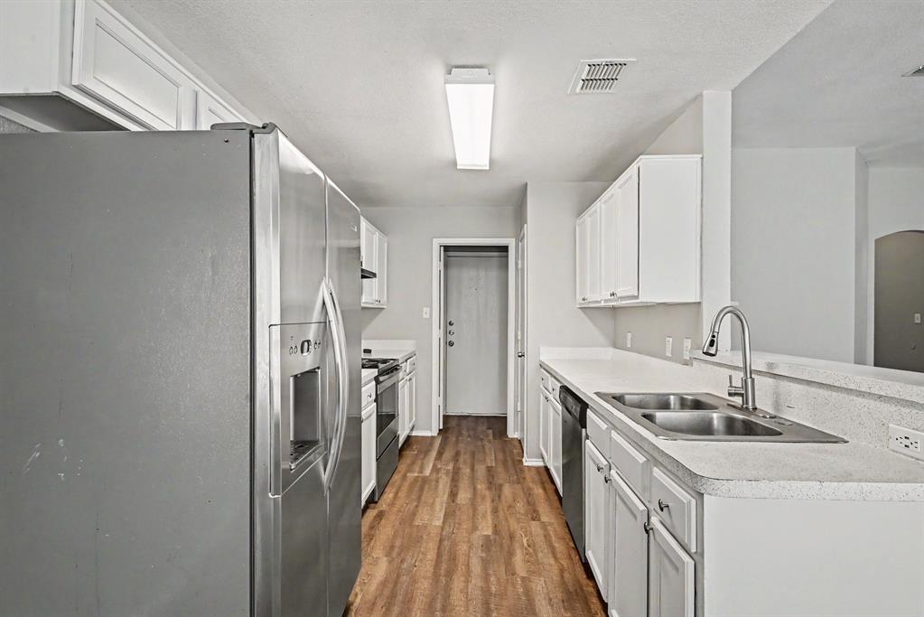 138 Kings Way Drive Rhome, TX 76078 - Photo 6 of 16 a kitchen with a sink stove and refrigerator