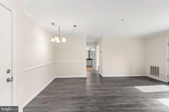 a view of a room with wooden floor and staircase