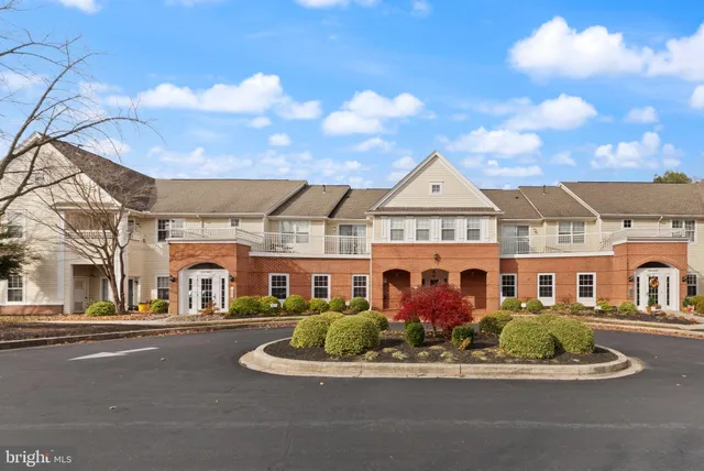 a view of a white house with a space and street view