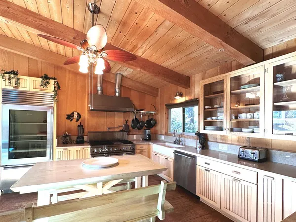 a kitchen with stainless steel appliances kitchen island granite countertop a sink and cabinets