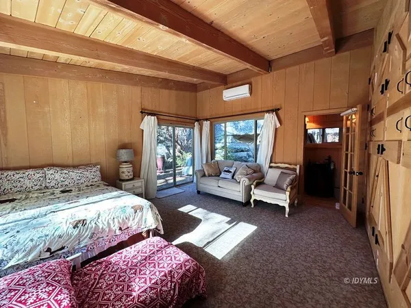 a bedroom with a bed couch and a window