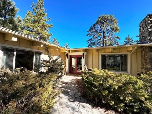 a view of a house with a tree in a yard