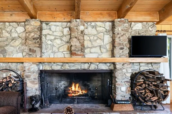 a room with a fireplace and a flat screen tv