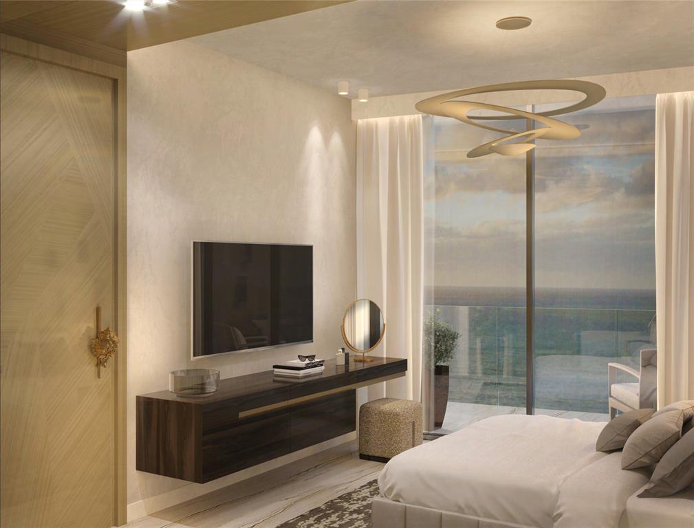 3319 North Ocean Drive, Unit 702 Hollywood, FL 33019 - Photo 17 of 23 a room with a bed and a mirror