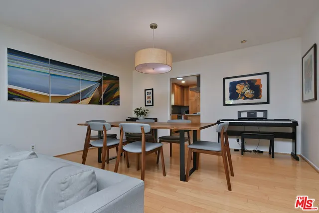 a kitchen with stainless steel appliances granite countertop white cabinets window and a sink