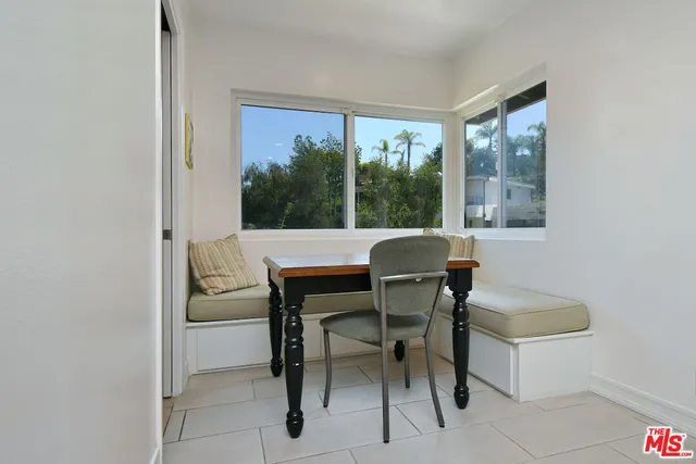 a bedroom with a bed dresser and a window