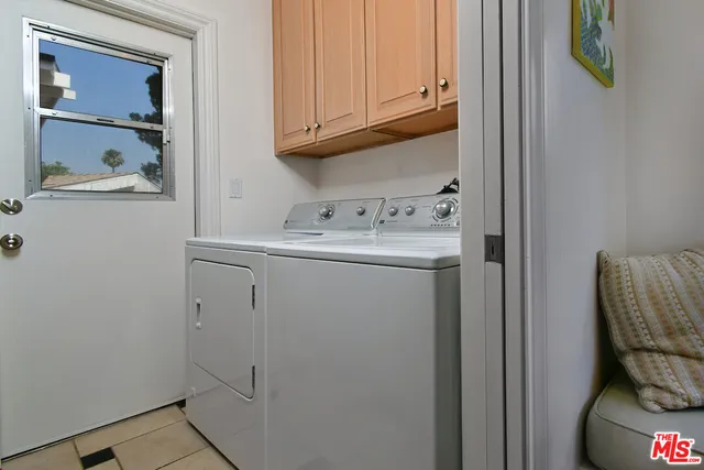 a bed room with a bed mirror and a window