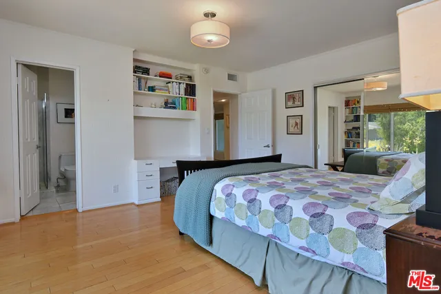 a bedroom with a bed and dresser