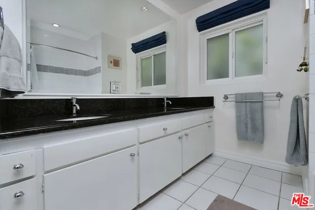 a bedroom with a bed and a flat screen television