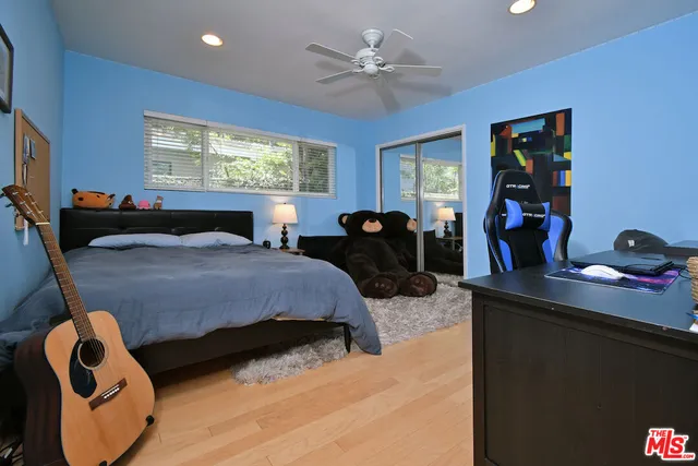 a bedroom with a bed and a lamp