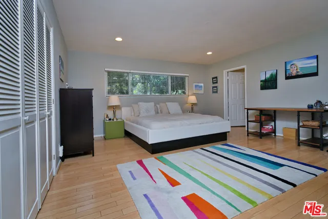 a spacious bathroom with a double vanity sink and a mirror