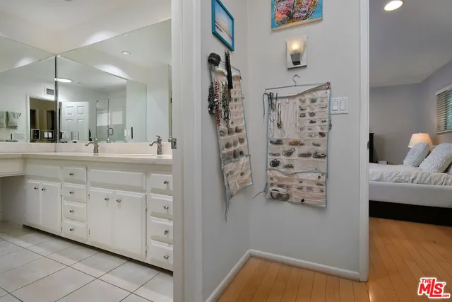 a view of a patio with table and chairs potted plants with floor to ceiling window and tree