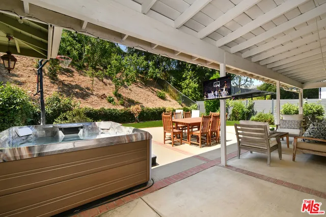 a view of a house with backyard porch and sitting area