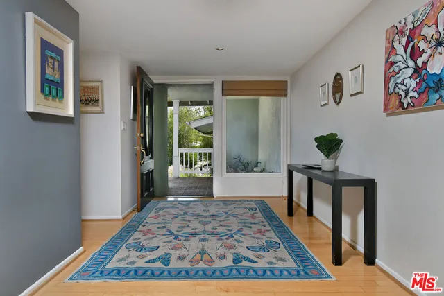 a living room with furniture a rug and a fireplace
