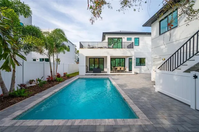 a bathroom with double vanity sinks and a mirror