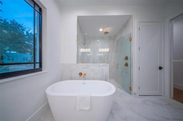 a bathroom with a granite countertop sink a toilet and shower
