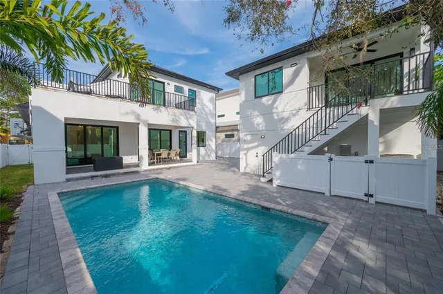 a living room with furniture a flat screen tv and a large window