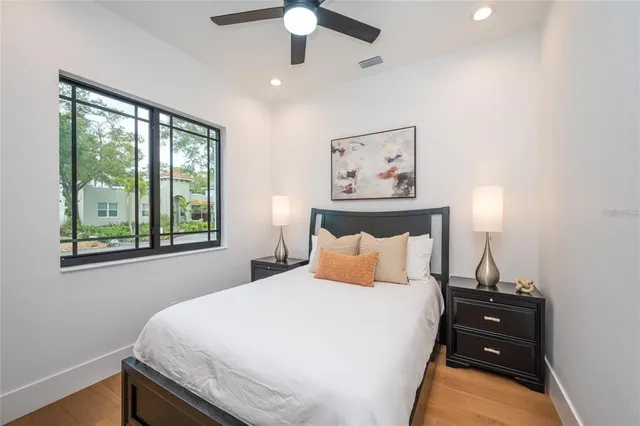 a bedroom with a bed and a large window