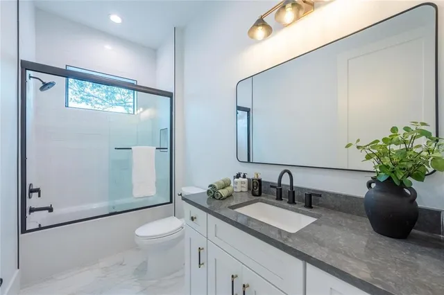 a front view of a building with a garden