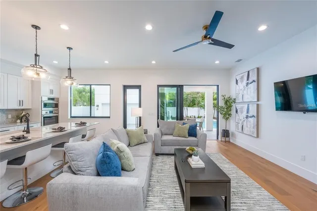 a kitchen with stainless steel appliances granite countertop a sink a stove and a white cabinets