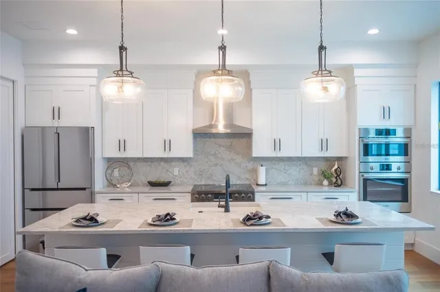 a large bed in a bedroom next to a window