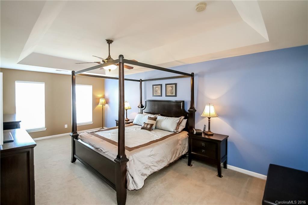 382 Fischer Road Fort Mill, SC 29715 - Photo 12 of 24 a bedroom with a bed and a lamp next to a window