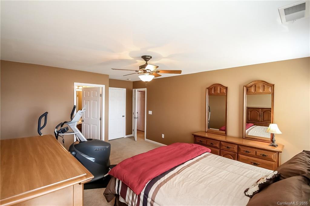 382 Fischer Road Fort Mill, SC 29715 - Photo 16 of 24 a bedroom with a bed and lamp chandelier