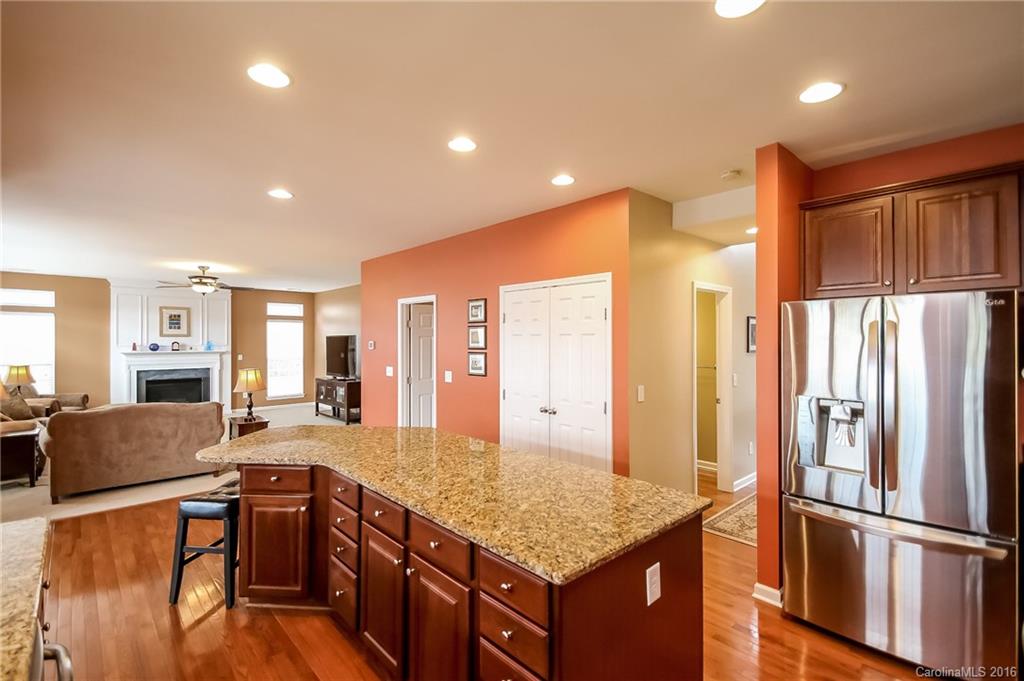 382 Fischer Road Fort Mill, SC 29715 - Photo 5 of 24 a kitchen with stainless steel appliances granite countertop a refrigerator a stove and a sink with wooden floor