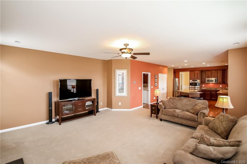 382 Fischer Road Fort Mill, SC 29715 - Photo 9 of 24 a living room with furniture a flat screen tv and a chandelier