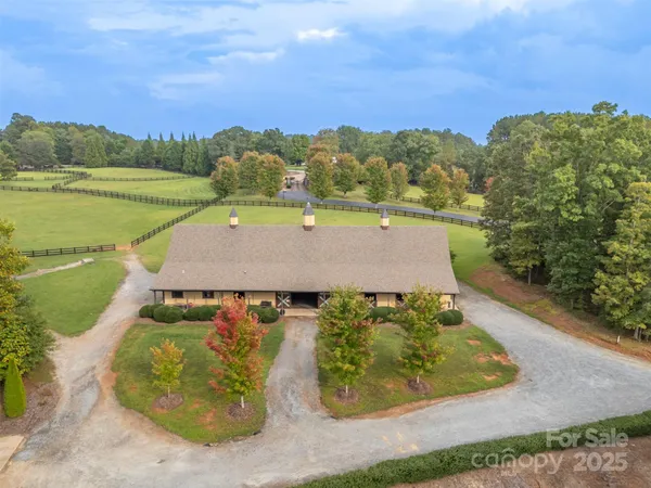 an aerial view of a house with a yard and lake view