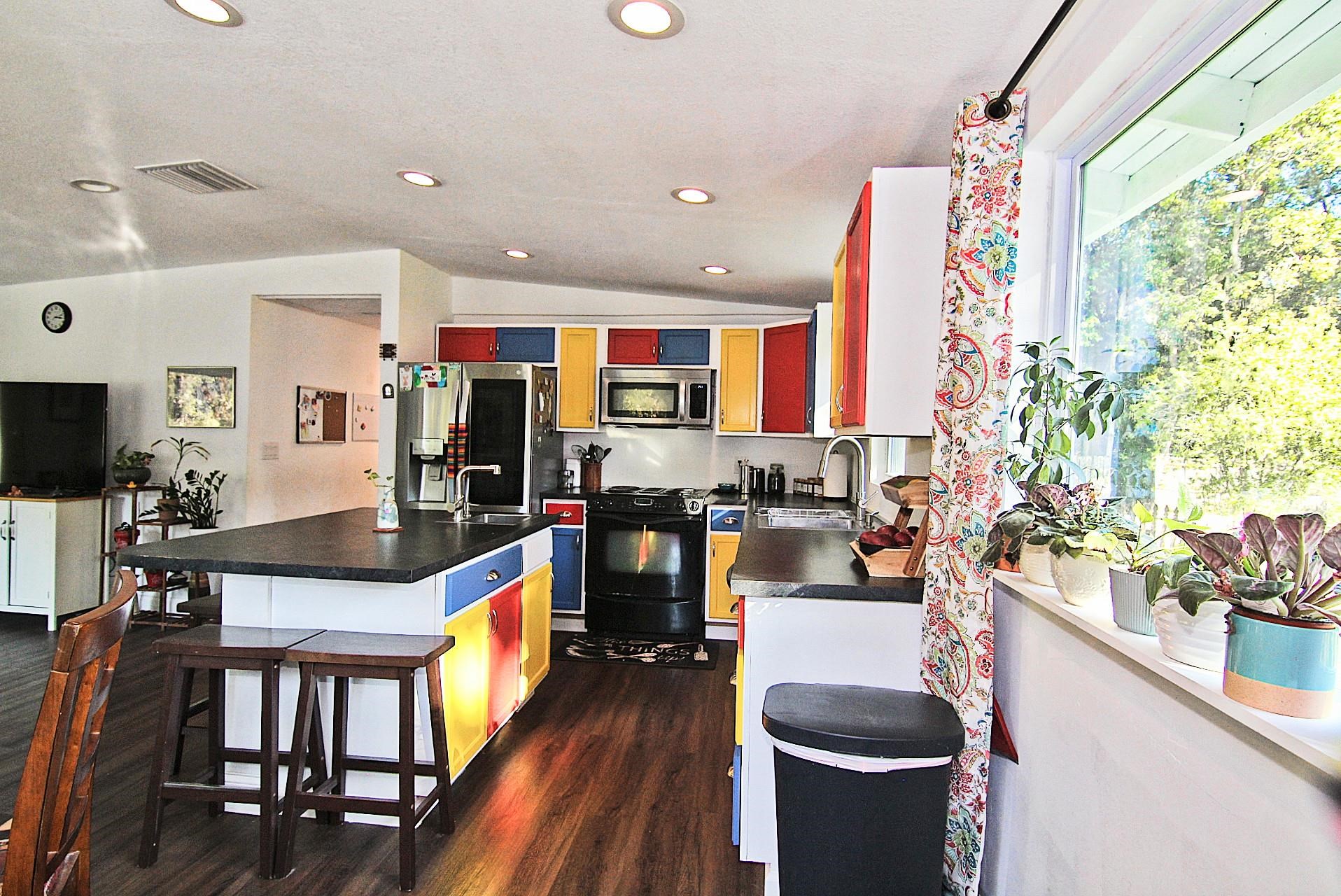 561 Tart Road St. Augustine, FL 32084 - Photo 5 of 15 a living room with stainless steel appliances furniture a rug and a kitchen view