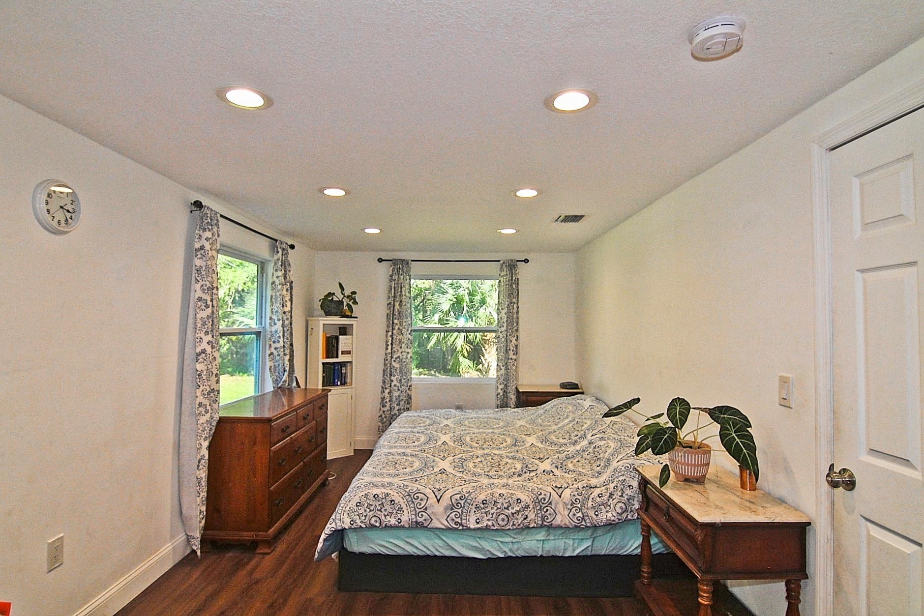 561 Tart Road St. Augustine, FL 32084 - Photo 7 of 15 a bedroom with a bed and wooden floor