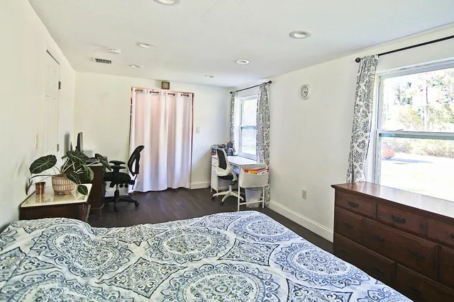 a bedroom with furniture and a window