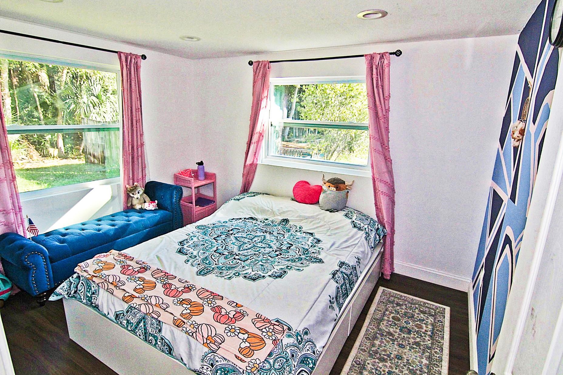 561 Tart Road St. Augustine, FL 32084 - Photo 10 of 15 a bed sitting in a bedroom next to a window