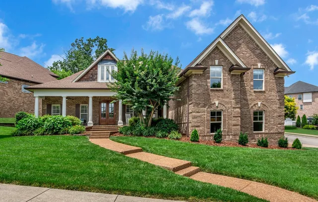a front view of a house with a yard