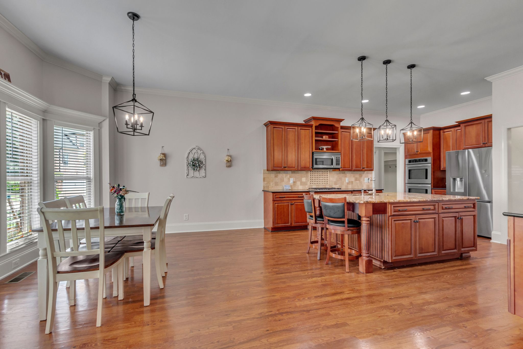 1051 Fitzroy Circle Spring Hill, TN 37174 - Photo 16 of 38 a kitchen with stainless steel appliances granite countertop a stove top oven a dining table and chairs