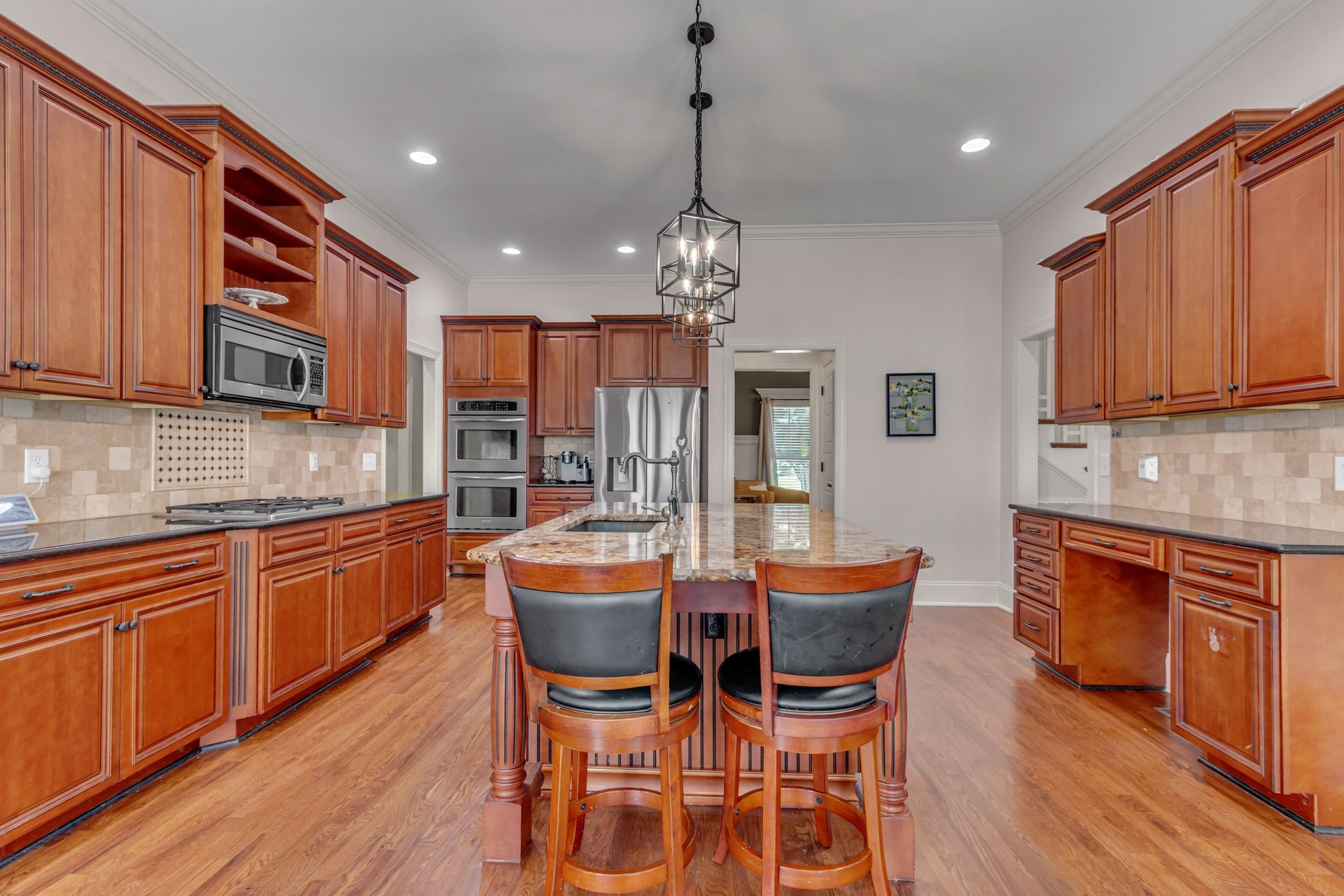 1051 Fitzroy Circle Spring Hill, TN 37174 - Photo 17 of 38 a kitchen with stainless steel appliances granite countertop wooden cabinets a dining table and chairs
