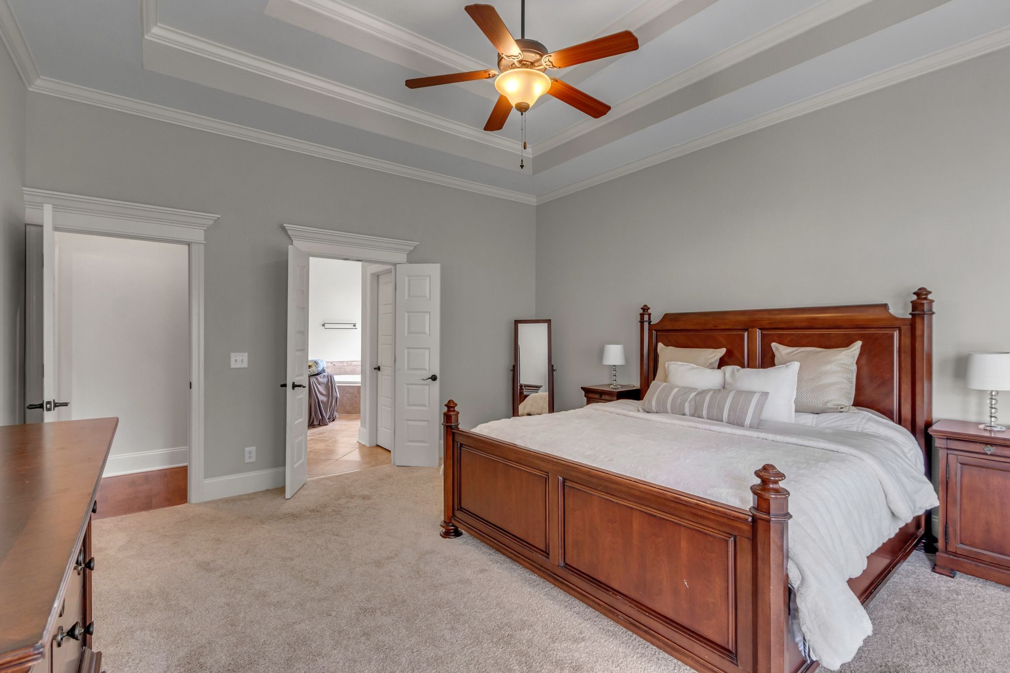 1051 Fitzroy Circle Spring Hill, TN 37174 - Photo 22 of 38 a bedroom with a bed and a chandelier