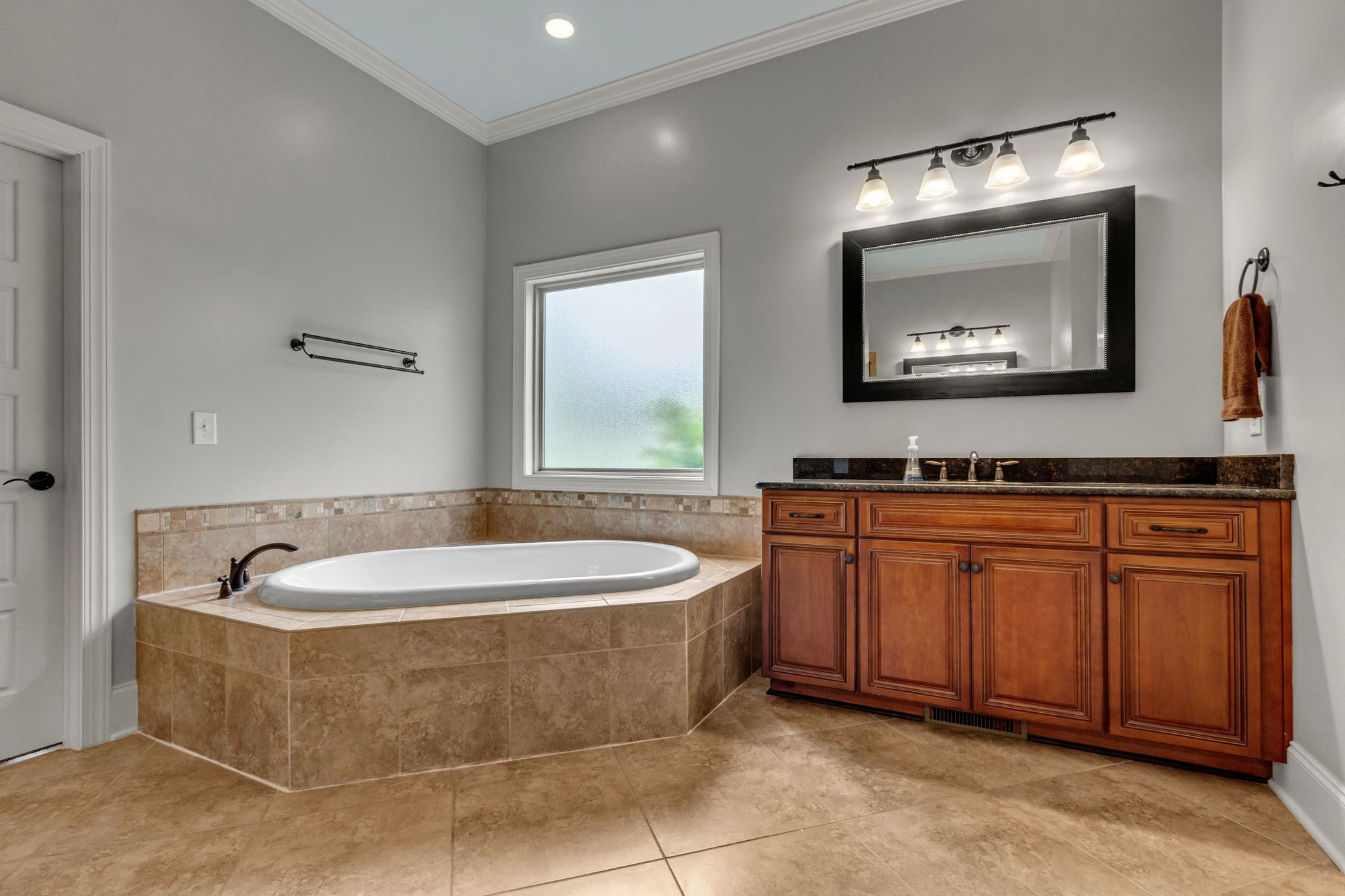 1051 Fitzroy Circle Spring Hill, TN 37174 - Photo 25 of 38 a spacious bathroom with a tub sink and mirror